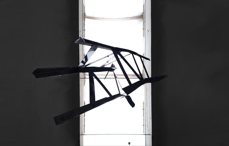 Truss/crane structure hanging above view, illuminated from above by skylight